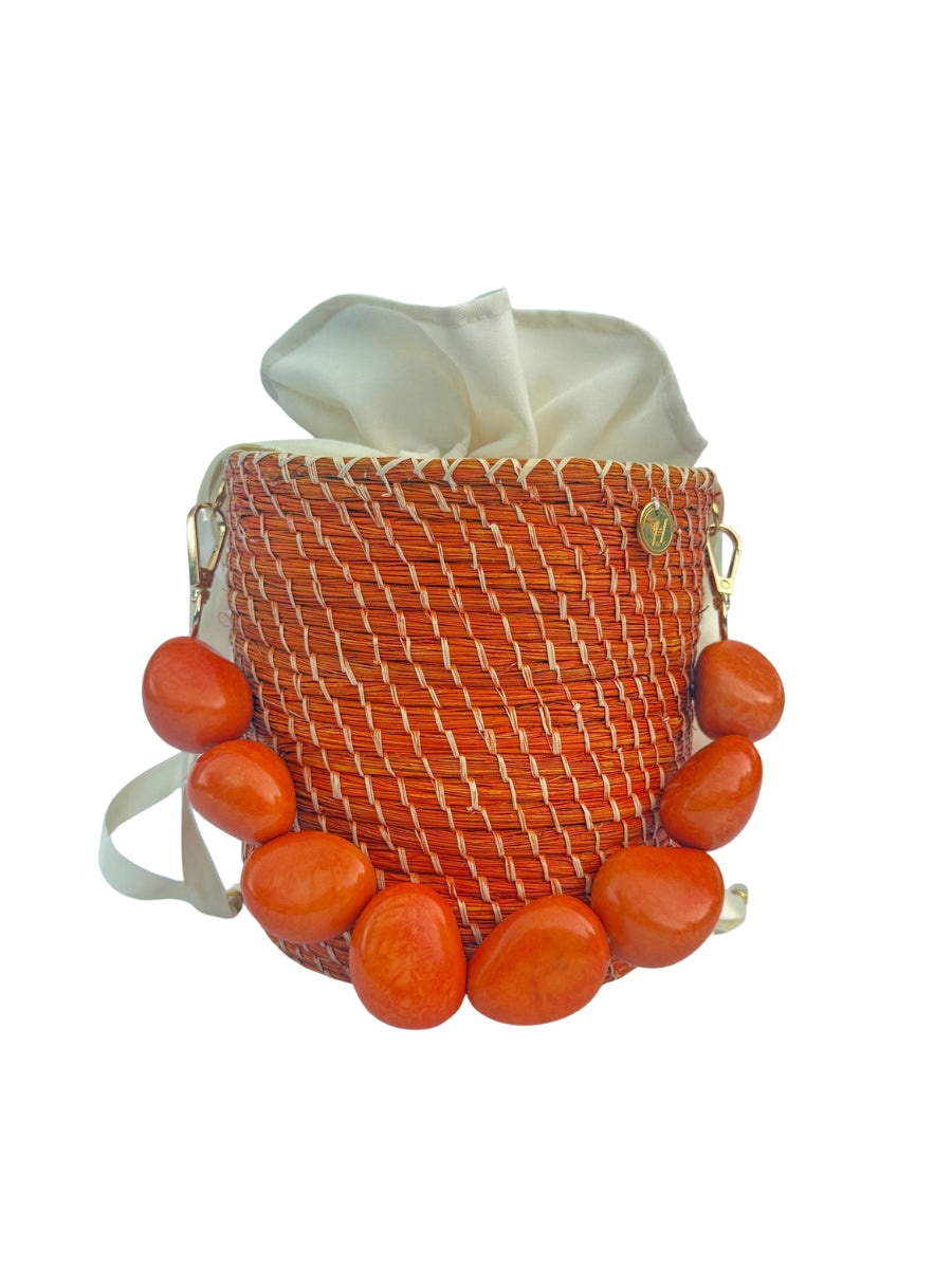 Woven rattan bucket bag with traditional artisan craftsmanship
