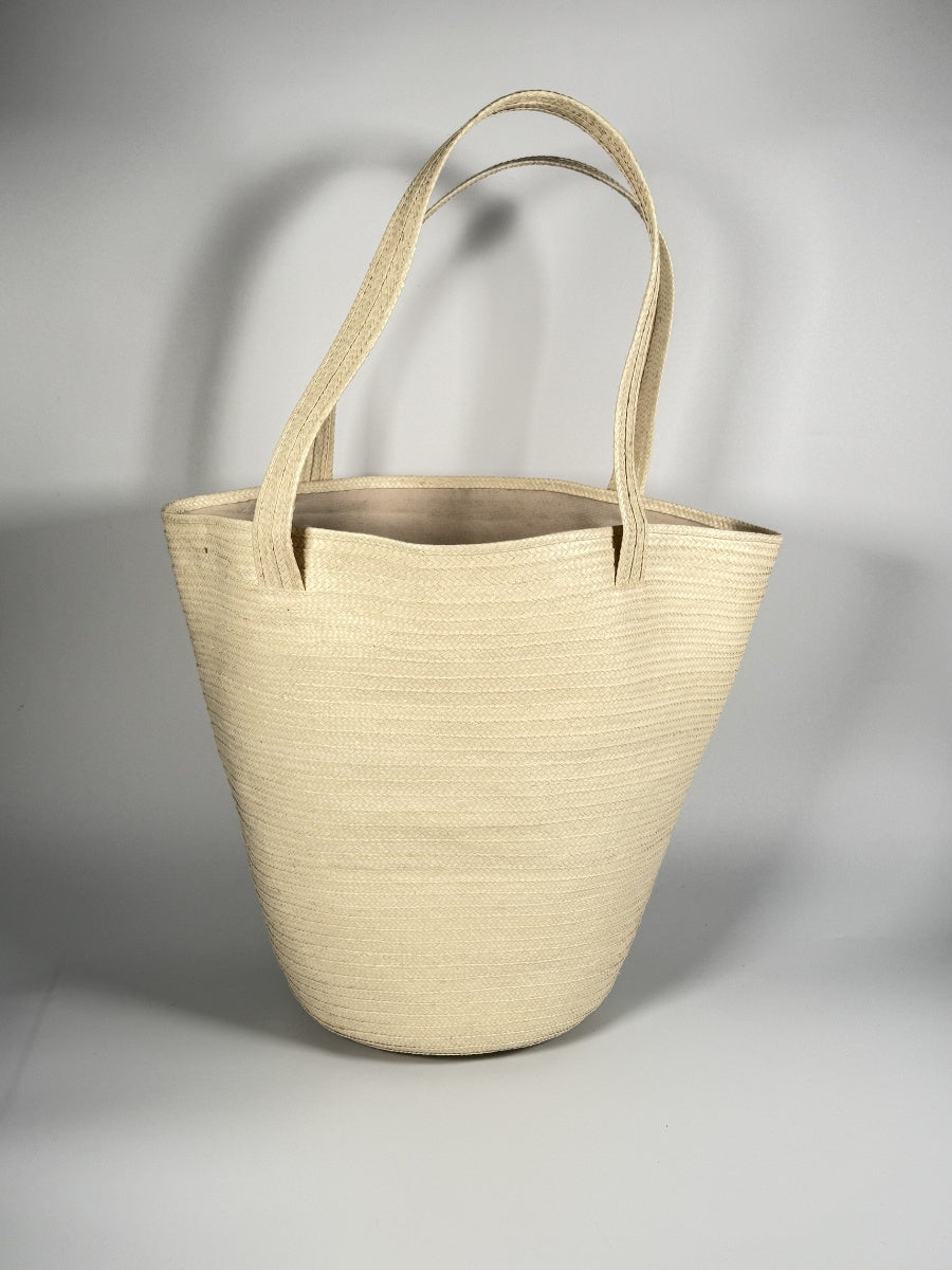 Handwoven palm leaf bag with artisan detailing