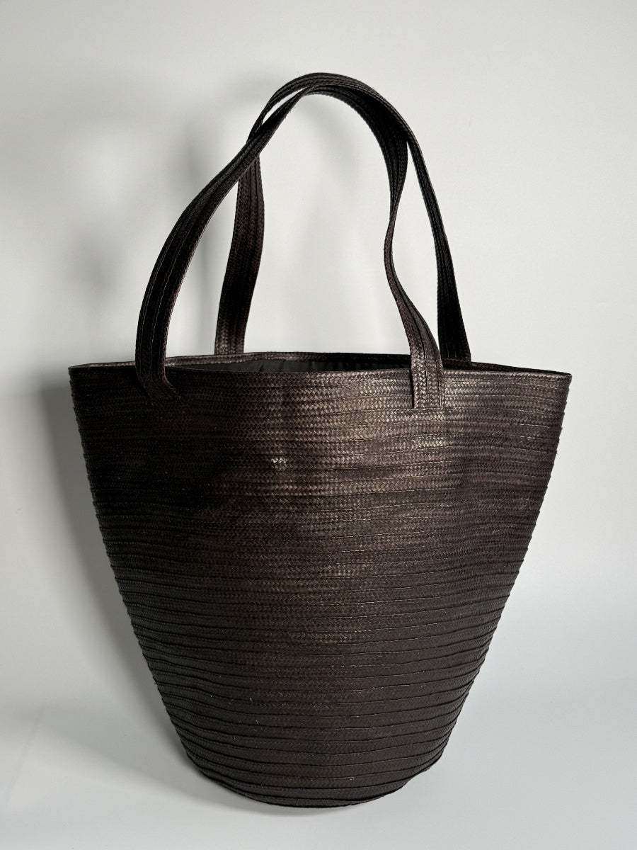 Handwoven palm leaf bag with artisan detailing